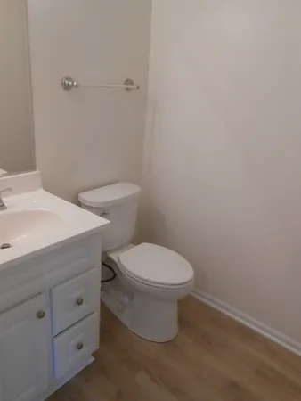 a white toilet sitting next to a bathroom sink
