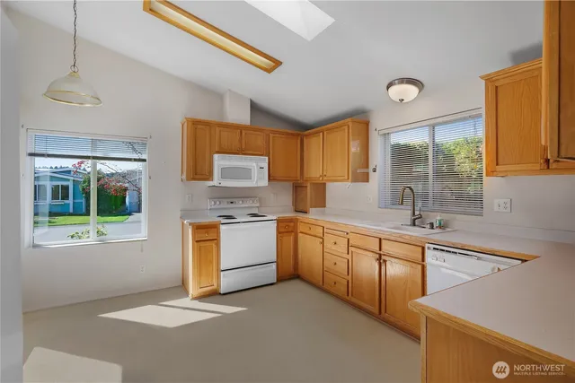 a kitchen with stainless steel appliances granite countertop a sink stove and cabinets