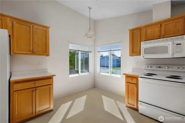 a kitchen with stainless steel appliances granite countertop a refrigerator and a stove