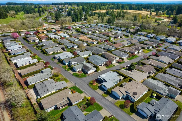 an aerial view of a house with a garden and parking space