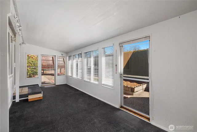 a living room with furniture and large windows
