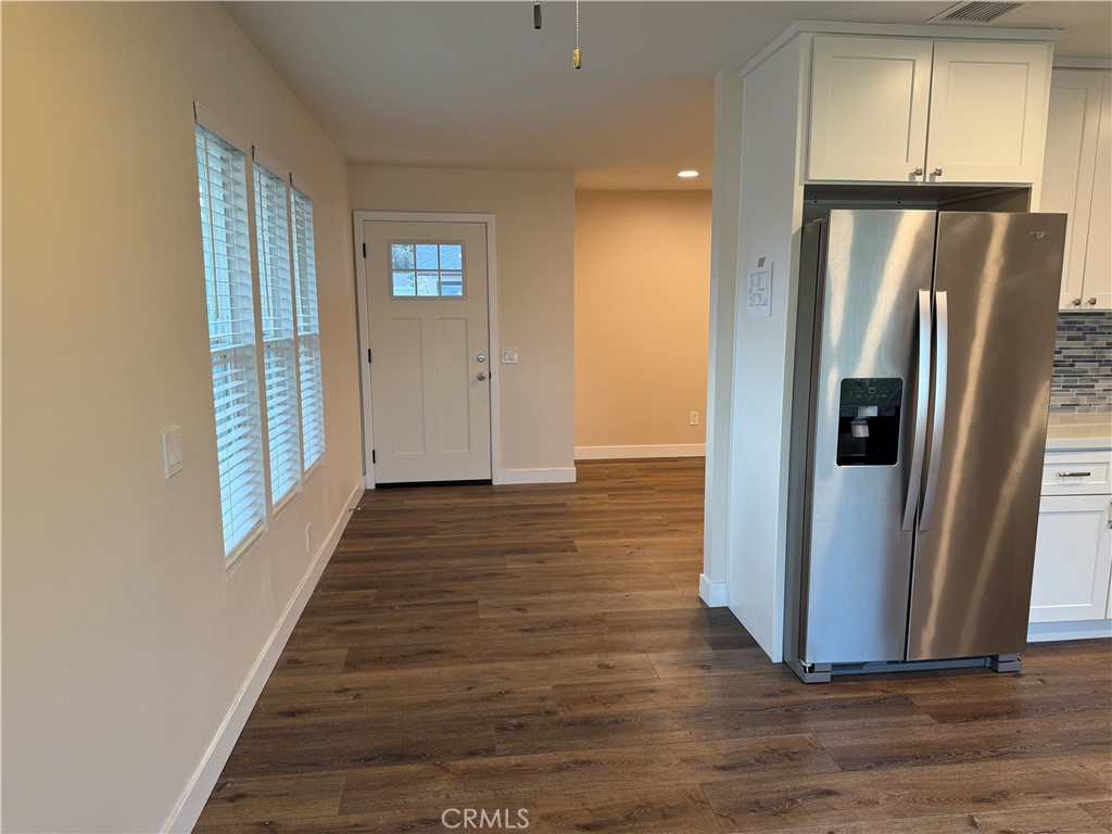 41134 Vía Halcon Temecula, CA 92591 - Photo 18 of 28 a view of a refrigerator in kitchen and wooden floor
