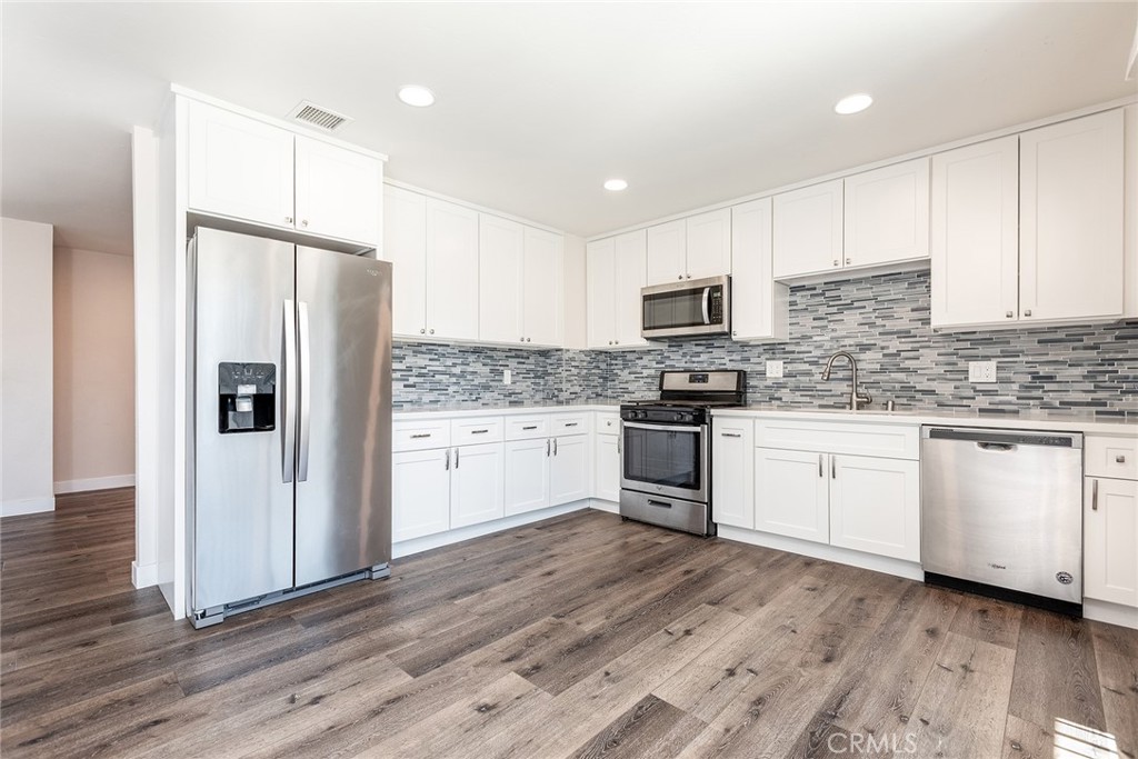 41134 Vía Halcon Temecula, CA 92591 - Photo 5 of 28 a kitchen with granite countertop white cabinets and stainless steel appliances