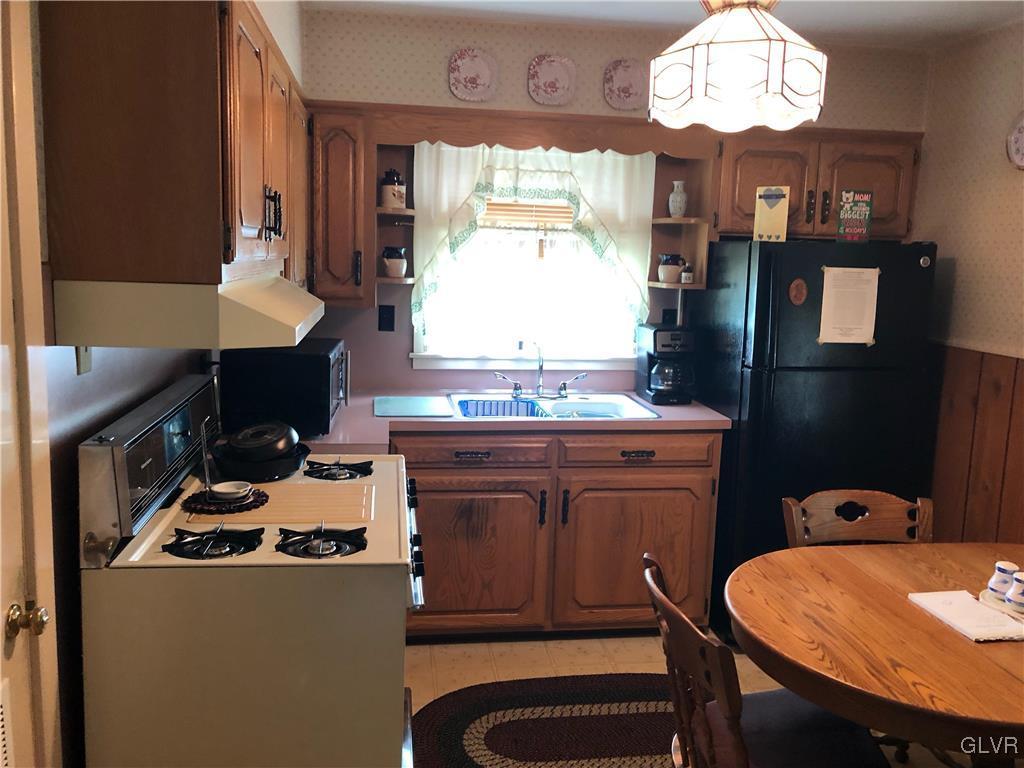 3733 Huckleberry Road Allentown, PA 18104 - Photo 2 of 15 a kitchen with sink a window and chairs