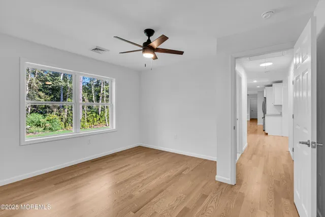 wooden floor in an empty room with a window