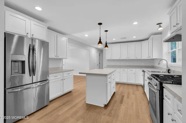 a kitchen with stainless steel appliances granite countertop a refrigerator a stove a sink dishwasher and a refrigerator