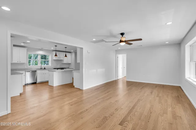 a view of kitchen with sink and wooden floor