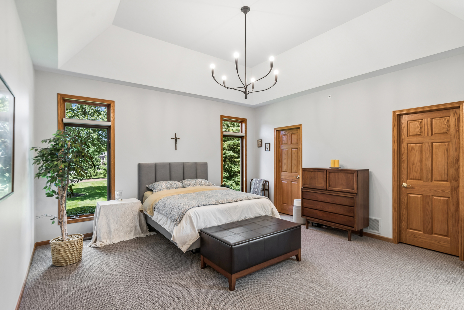 10907 Red Hawk Lane Spring Grove, IL 60071 - Photo 17 of 44 a bedroom with a bed and a chandelier