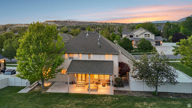 1712 Somerset Ridge Drive Draper, UT 84020 - Photo 69 of 76 Rear exterior featuring a covered patio, extensive concrete slab, and a spacious lawn