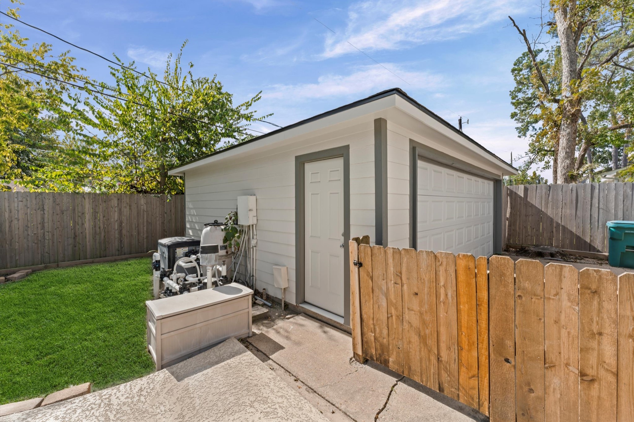 1219 Candlelight Lane Houston, TX 77018 - Photo 25 of 36 2-car garage also has a convenient pedestrian door for accessing those gardening or pool tools. Side gate to the driveway keeps little ones away from cars.
