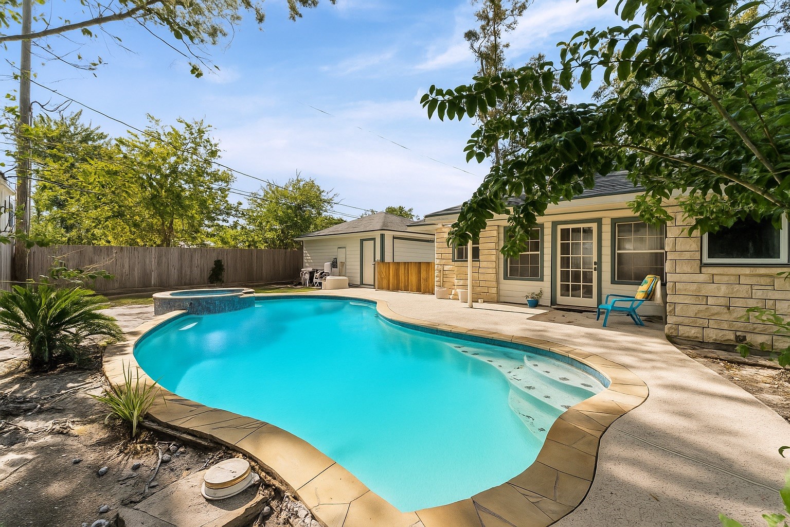 1219 Candlelight Lane Houston, TX 77018 - Photo 4 of 36 The pool-centered backyard invites relaxed afternoons and easy entertaining, with a covered back porch offering shaded comfort. French doors connect indoor living to the outdoors, creating a natural flow designed for everyday enjoyment in Houston’s climate.