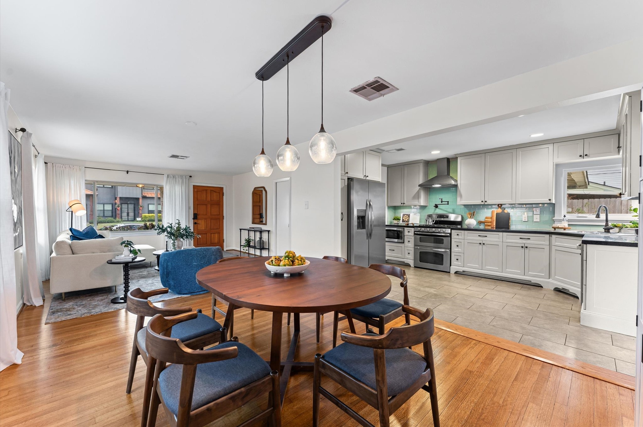 1219 Candlelight Lane Houston, TX 77018 - Photo 6 of 36 This flexible layout keeps the kitchen open to the dining and living areas, yet subtly tucked away for hosting. Fresh finishes and natural light make the entire space feel bright and welcoming.