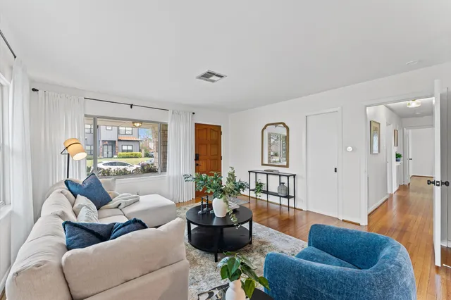 a living room with furniture or couch and a wooden floor