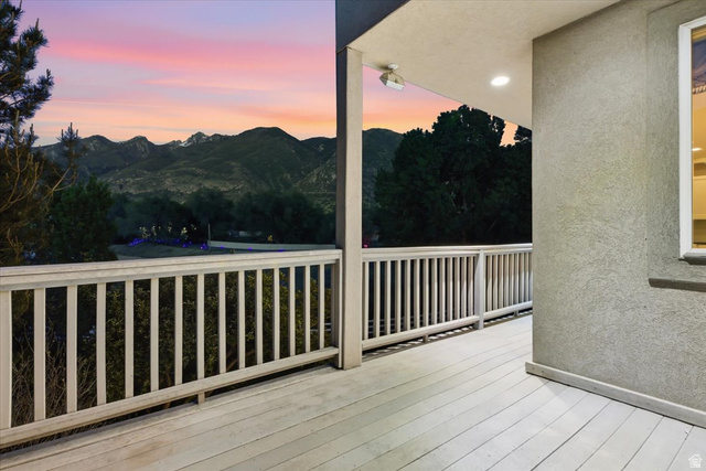12317 Cypress Point Way Draper, UT 84020 - Photo 33 of 41 Spacious outdoor deck featuring wood-finish flooring and a white railing, overlooking distant mountains