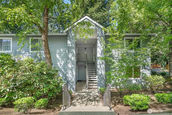 front view of a house with a tree