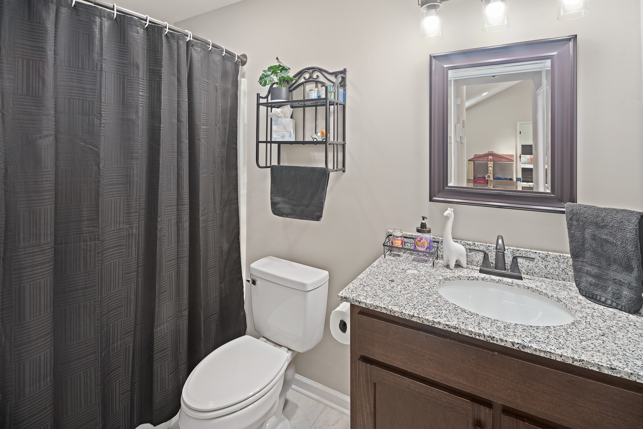 1550 South Spring Street Manchester, TN 37355 - Photo 18 of 26 a bathroom with a granite countertop sink mirror vanity and toilet