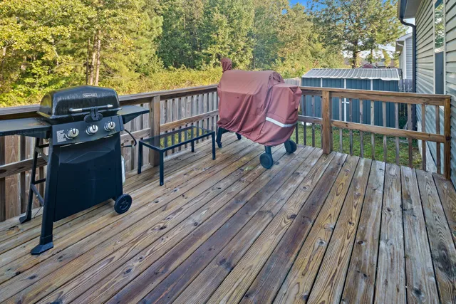 a view of a roof deck with wooden floor and outdoor seating