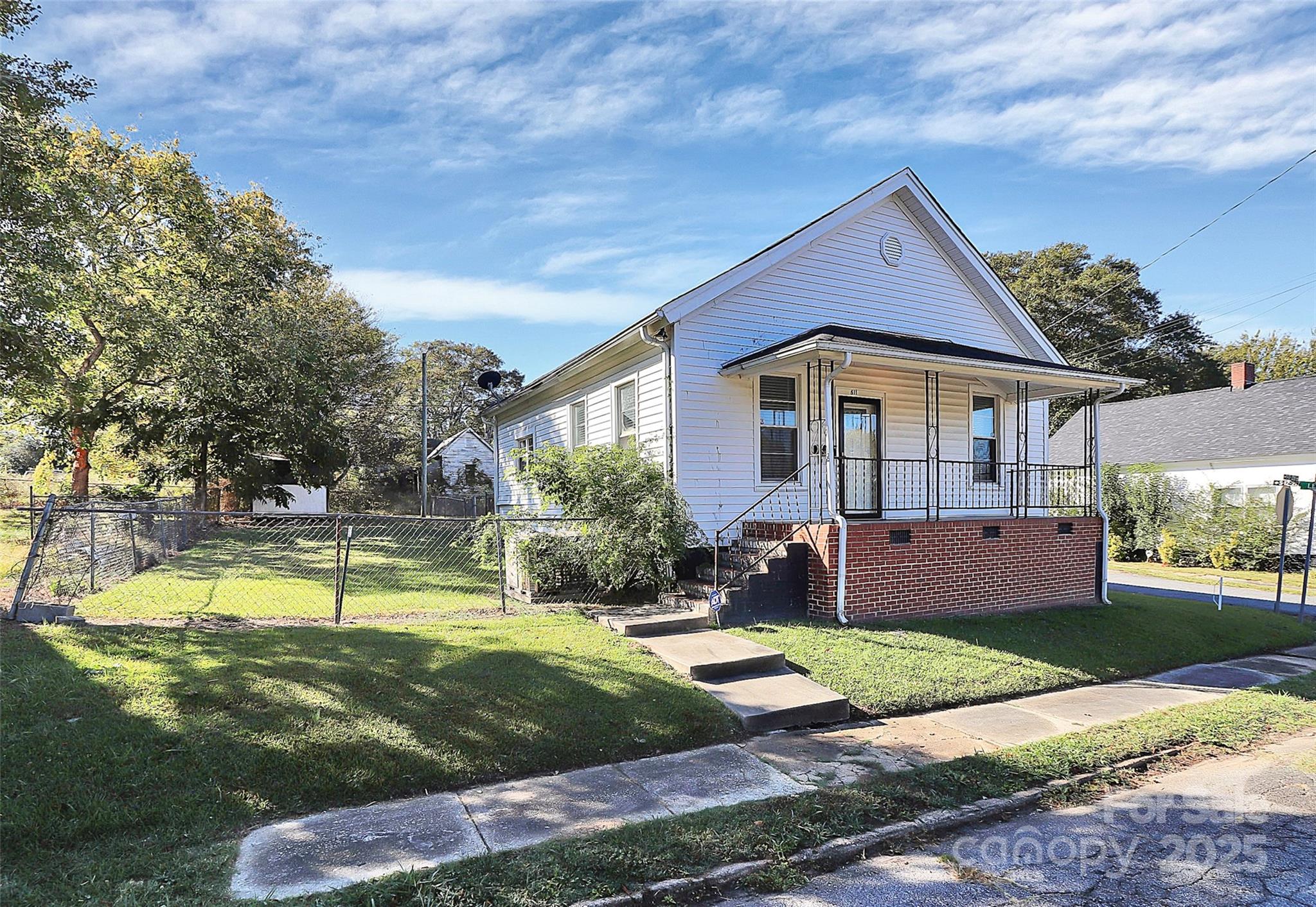 a view of a house with swimming pool and a yard