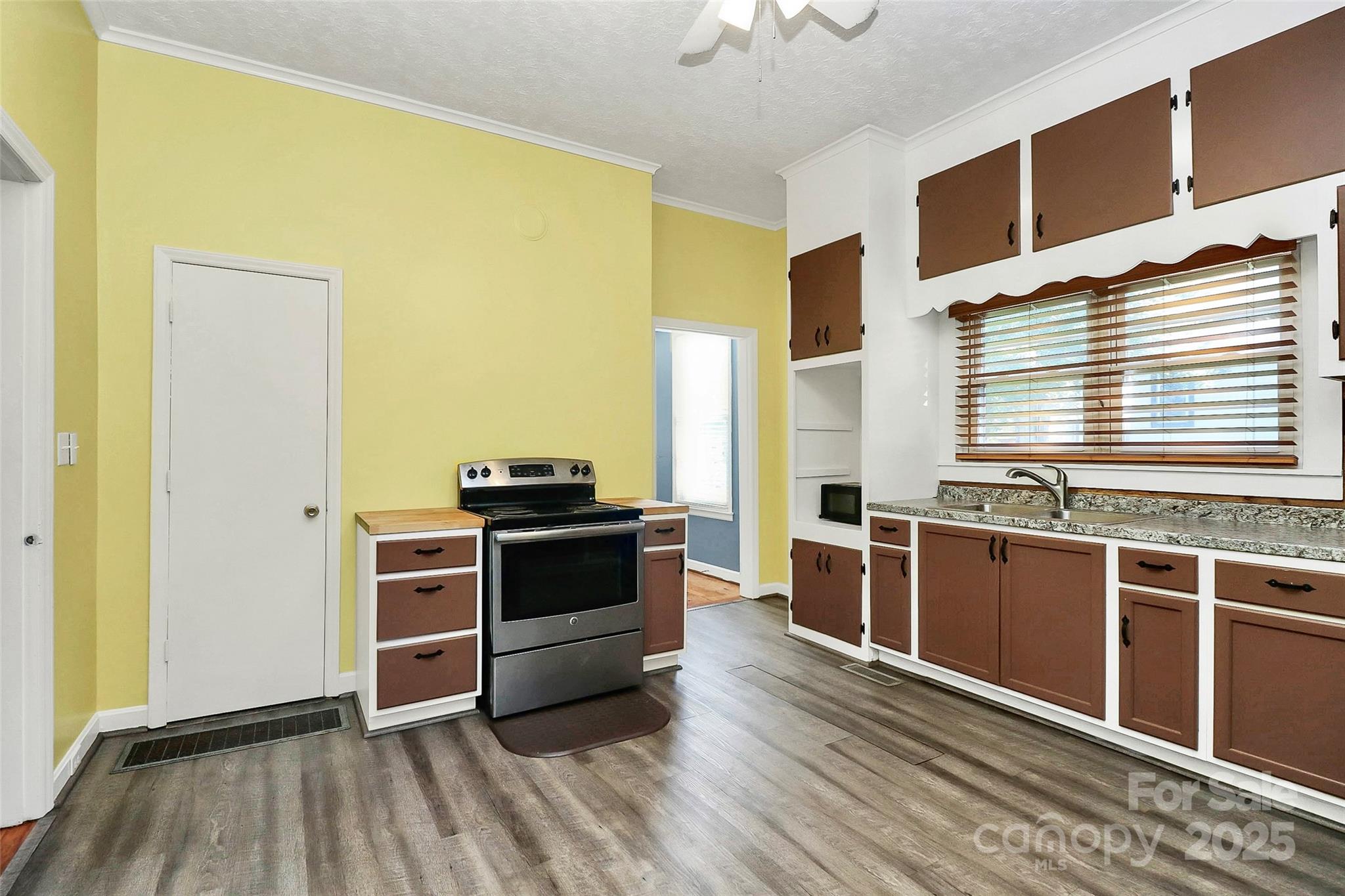 511 West Elliott Street Chester, SC 29706 - Photo 18 of 32 a kitchen with stainless steel appliances granite countertop a stove and a sink