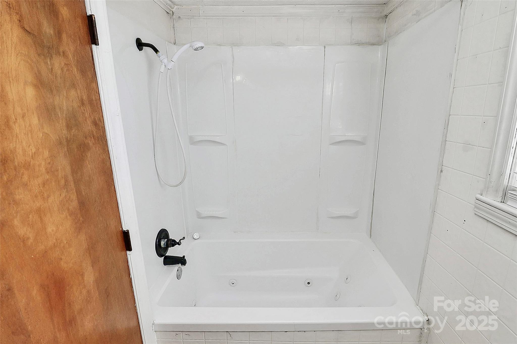 511 West Elliott Street Chester, SC 29706 - Photo 26 of 32 a white bath tub sitting next to a white sink and vanity