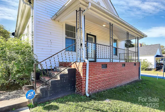 a view of a wooden house with a yard