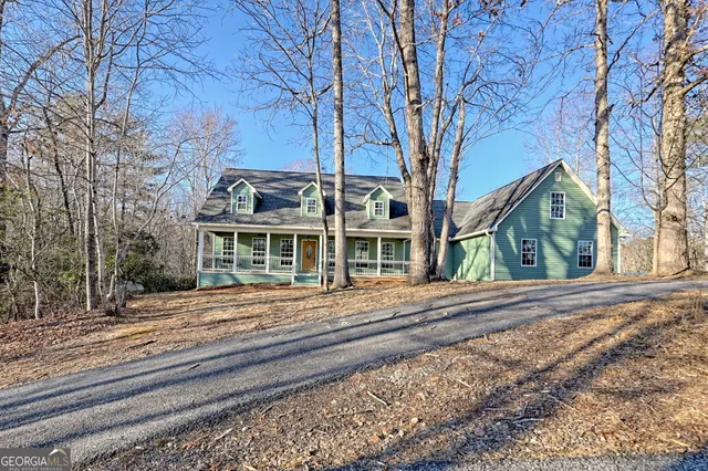 a view of a yard with large trees
