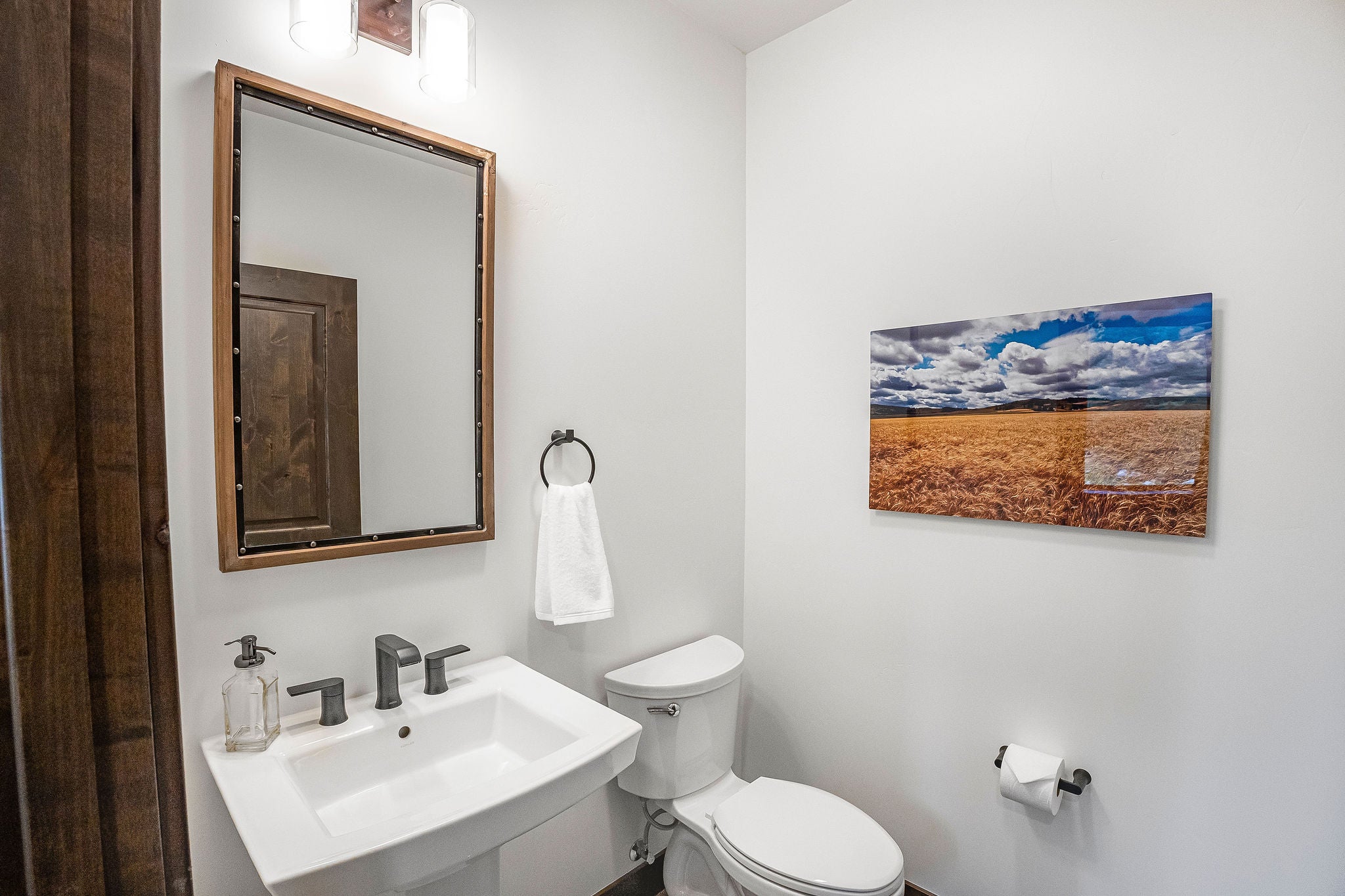 77 Rumsey Road Philipsburg, MT 59858 - Photo 45 of 76 Half bath featuring toilet, a sink, and baseboards