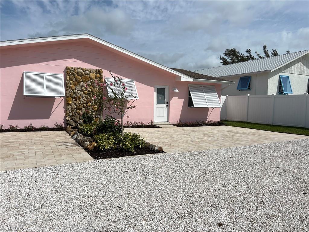 1793 Smugglers Cove, Unit B Naples, FL 34112 - Photo 1 of 23 a front view of a house with a yard