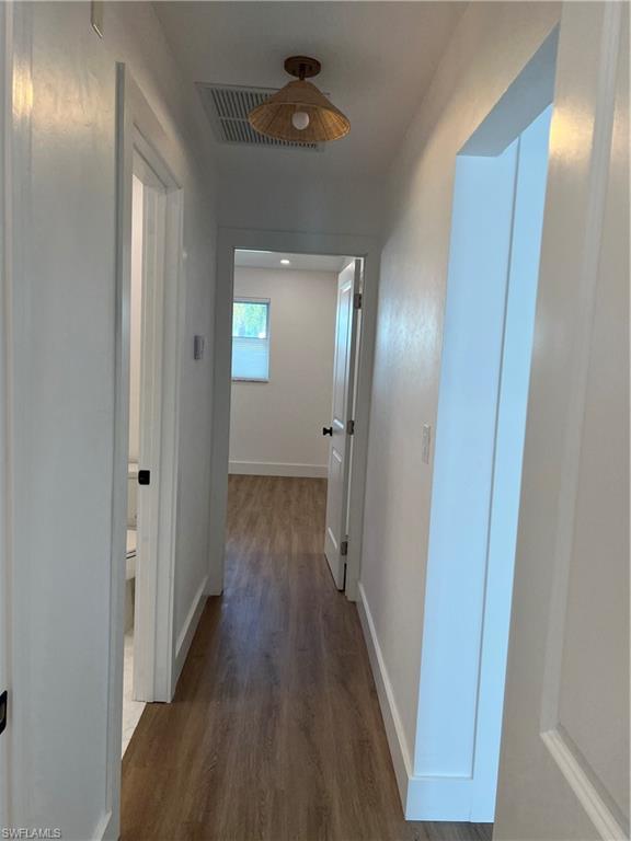 1793 Smugglers Cove, Unit B Naples, FL 34112 - Photo 17 of 23 a view of a hallway with wooden floor