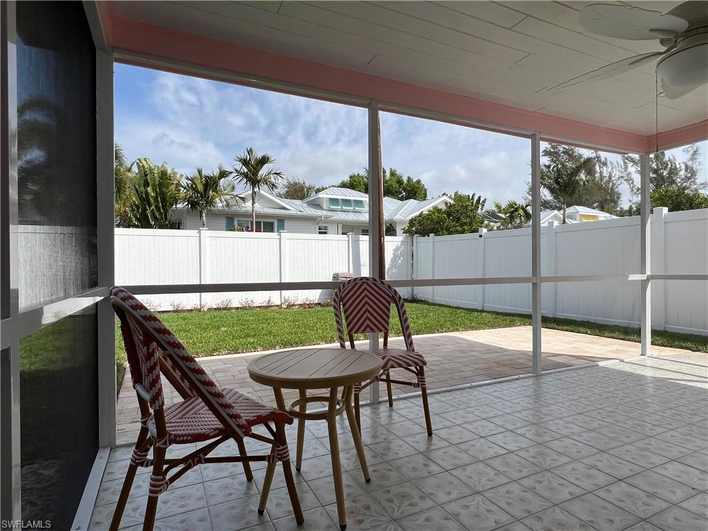 1793 Smugglers Cove, Unit B Naples, FL 34112 - Photo 23 of 23 a view of a patio with a table chairs and a table