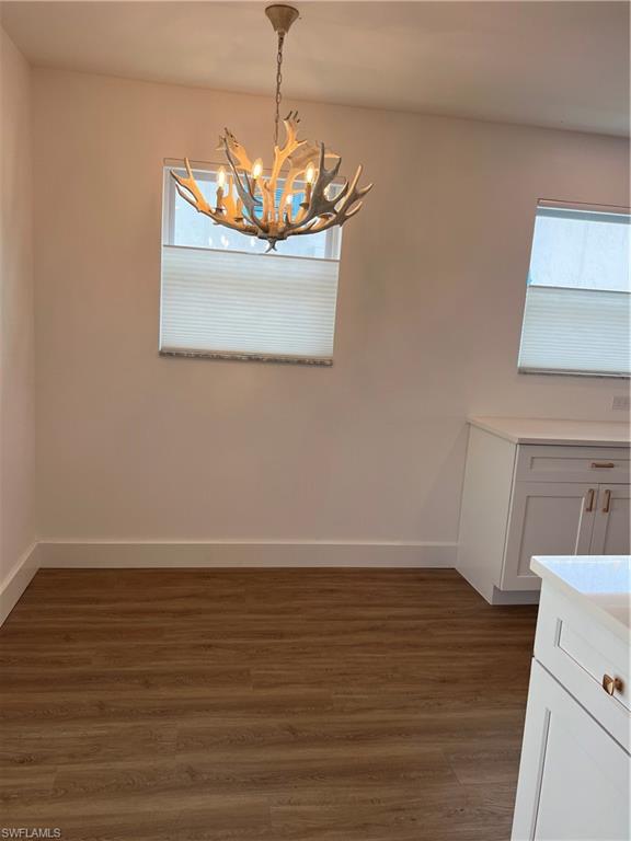 1793 Smugglers Cove, Unit B Naples, FL 34112 - Photo 9 of 23 a view of a room with wooden floor chandelier and entryway