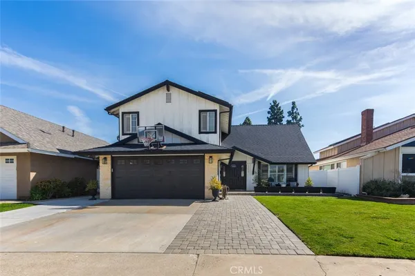 a front view of a house with yard and garage