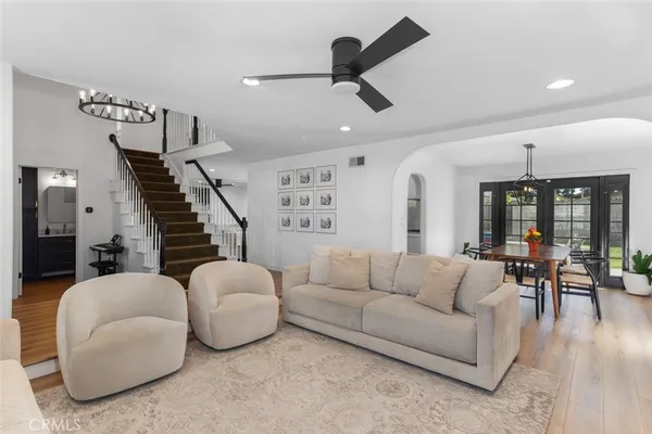 a living room with furniture and wooden floor