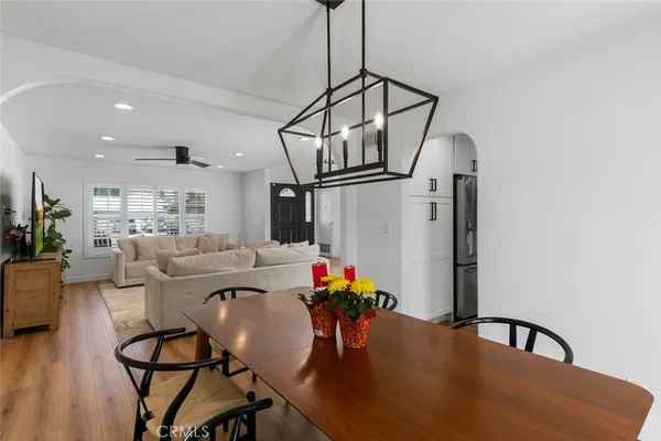 a view of a dining room with furniture and a potted plant