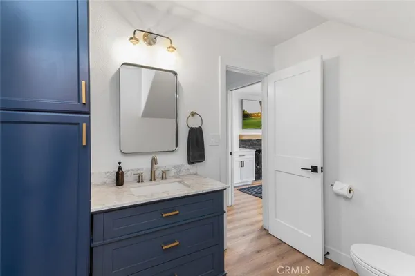 a bathroom with a sink vanity granite and a mirror