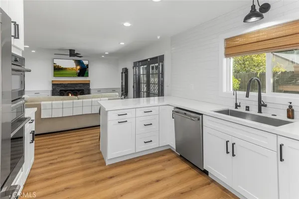 a kitchen with white cabinets and a sink