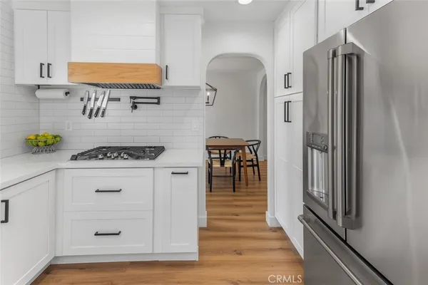 a kitchen with stainless steel appliances a refrigerator and a stove top oven