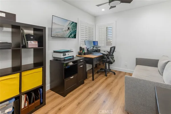 a view of a workspace with furniture and a window