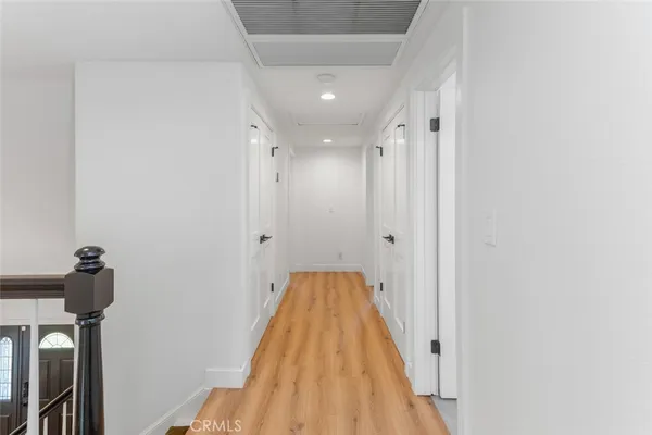 a view of a hallway with wooden floor