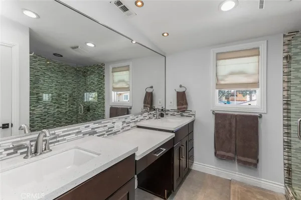 a bathroom with a sink double vanity and a mirror