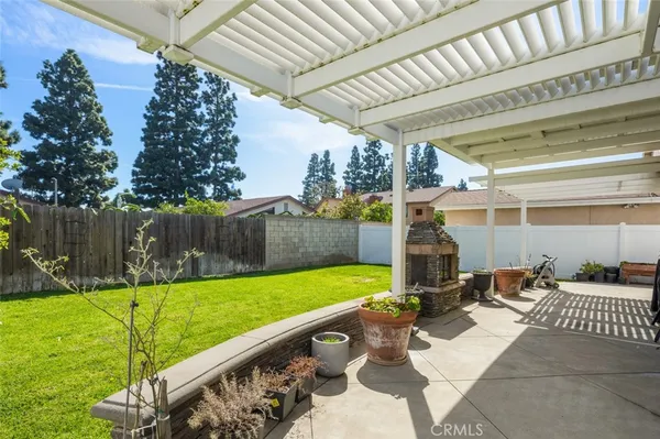 a view of a backyard with wooden fence