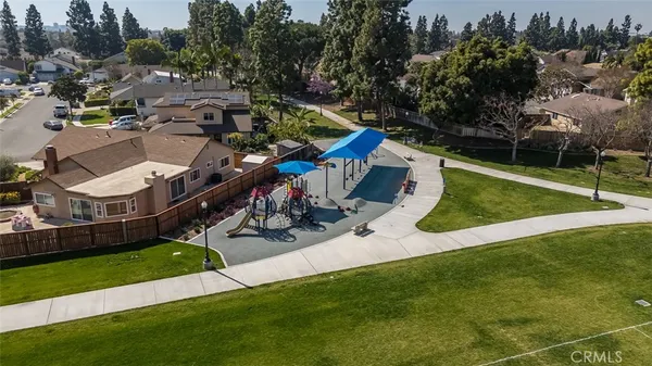 an aerial view of a house with a garden and trees