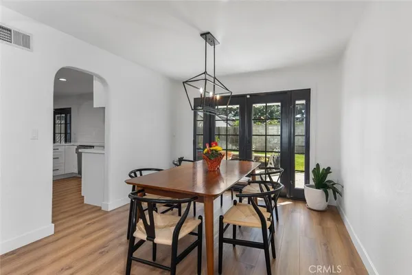 a dining room with furniture window and wooden floor