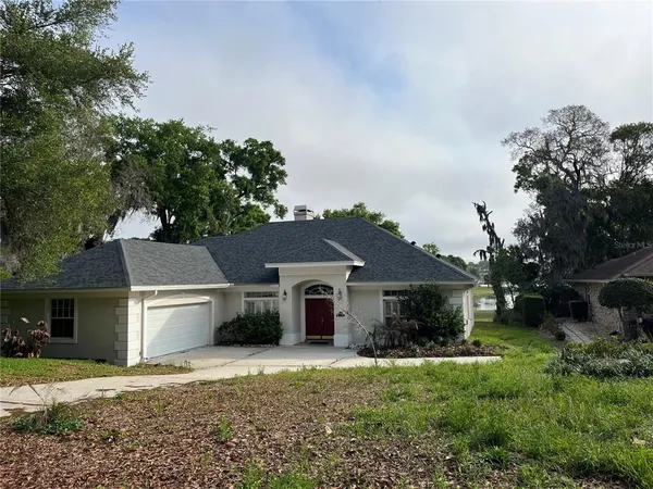 a front view of a house with a garden and yard