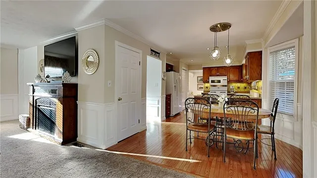 a view of a dining room with furniture window and wooden floor