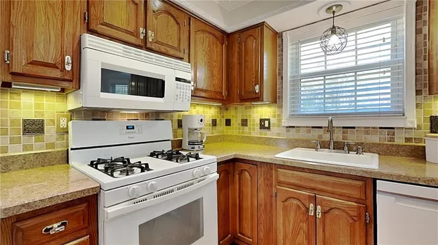 a kitchen with a stove a sink and a microwave