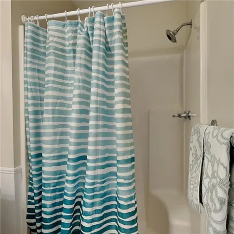 a bathroom with a shower curtain and a shower curtain