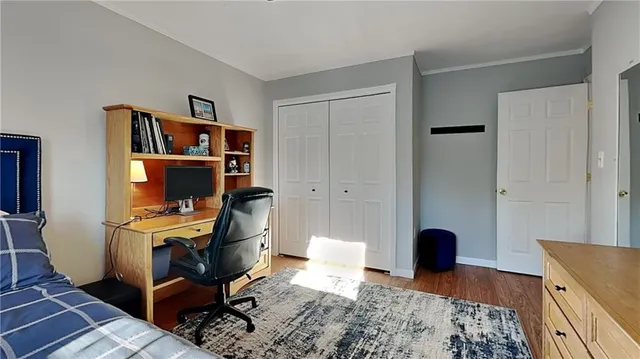 a view of a workspace with furniture and wooden floor