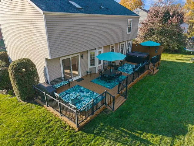 a view of a house with backyard and sitting area