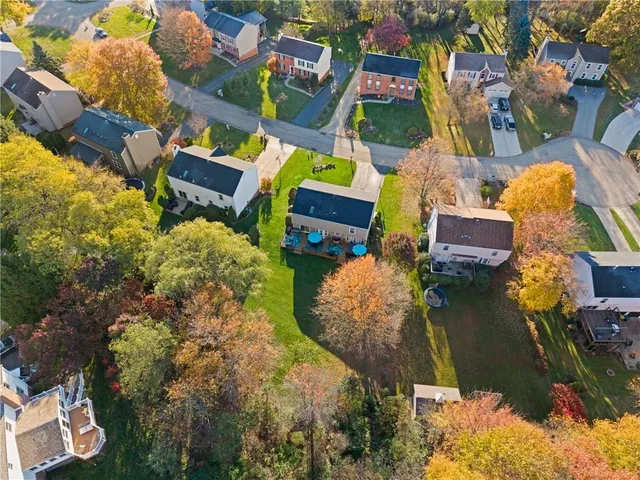 an aerial view of residential house with outdoor space and swimming pool